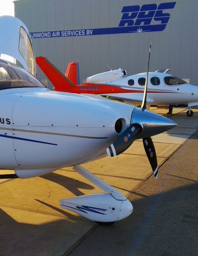 Cirrus SR20 from the side with VisionJet in background