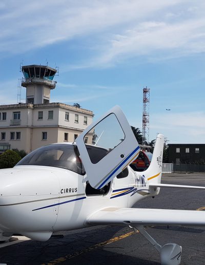 Cirrus SR20 Aircraft front of the tower